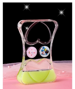 Detail of liquid motion timer featuring floating astronaut and bunny with green oil drops