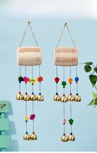 Détail d'un carillon en bois avec breloques poissons colorées et cloche dorée