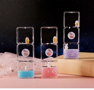 Macro detail of liquid hourglass desktop decor with cute rabbits and colorful sequins