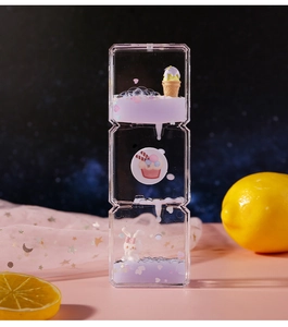 Detailed view of 3-layer liquid hourglass with purple fluid, cute rabbit and dessert figurines