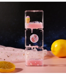Detail of pink liquid hourglass with cute ice cream bunny and floating dessert charms