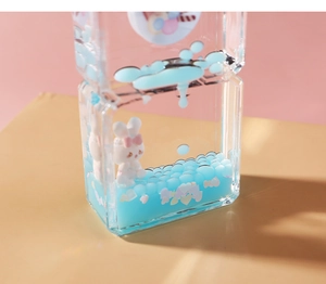 Close-up of heart sequins and blue fluid inside a cute creative bunny timer ornament