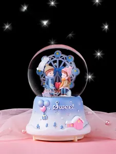 Detail of ferris wheel crystal ball music box with couple figures and blue base