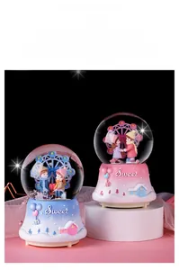 Detail view of pink and blue romantic ferris wheel crystal balls with Sweet resin base