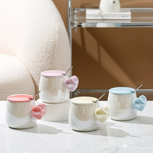 Set of four pastel ceramic heart handle mugs with matching lids and stainless steel spoons