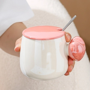 Ceramic heart coffee mug in cream white with pink handle and stainless steel spoon