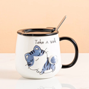 Cute white ceramic cat mug with black lid and metal spoon for morning coffee or milk