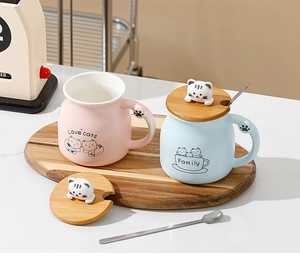Detail of ceramic cat mugs with 3D cat wooden lids, metal spoons, and Love Cats print