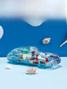 Macro detail of sports car shaped liquid timer with blue sand and sea shells