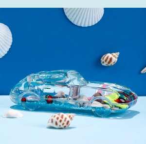 Macro shot of liquid motion timer car decor with shells and blue sand inside