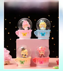 Detail view of four glowing crystal balls with cute girl figurines and butterfly bases