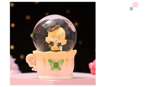 Detail of cartoon girl figurine in a glowing ocean crystal ball with seashell coffee cup base