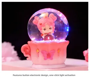 Glow crystal ball in pink coffee cup base with cartoon girl and LED light detail