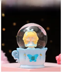 Luminous crystal ball with a cute anime girl figure on a blue decorative base