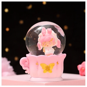 Detail shot of a glowing crystal ball featuring a cute cartoon girl in a pink cup base