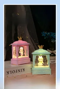 Macro view of pink and mint green royal pavilion music box with crown top and glitter