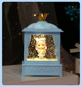 Detail of blue Lolita music box with LED warm lighting and cute figurine inside