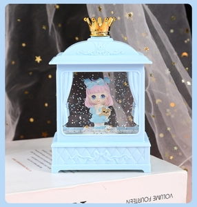 Detail of light blue crown crystal music box with cartoon girl and silver glitters