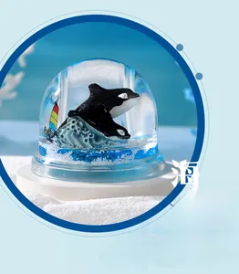 Detailed macro view of an orca crystal ornament with blue ocean liquid and white base