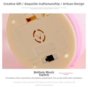 Detailed base view of the musical snow globe showing the battery compartment and switch
