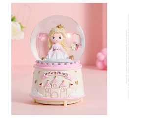 Detailed close-up of a pink princess castle music box with an intricate resin base