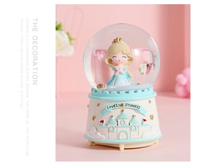 Detail of princess snow globe music box featuring lovely princess and castle base relief