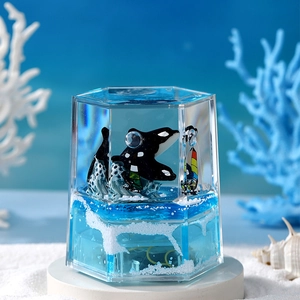 Hexagonal ocean liquid timer featuring an orca leaping over blue waves and white sand