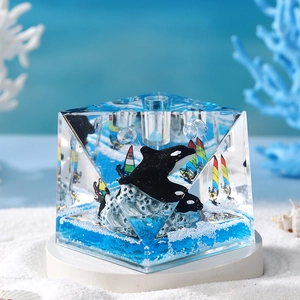 Orca whale resin cube ornament with ocean scene on a white round display base