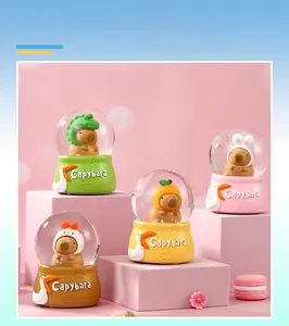 Close-up of four cute Capybara crystal ball night lights with assorted animal headwear