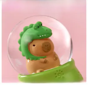 Macro detail of cute capybara resin figurine in crocodile hat inside crystal ball light