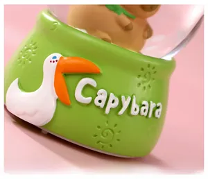 Detail of green resin base with Capybara text and white pelican relief for night light