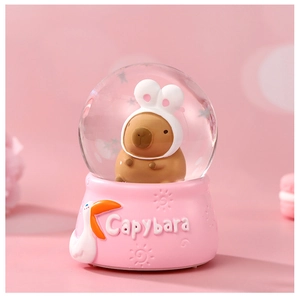 Detail of cute capybara crystal ball night light with pink base and soft lighting