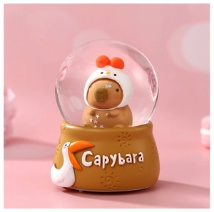Close-up of a Capybara crystal ball night light with a chicken hat and carved base