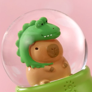 Luminous Capybara crystal ball night light with green dinosaur hat on round base