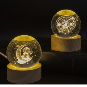Detailed view of 3D galaxy crystal ball night light with warm LED wooden base