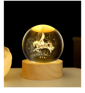 Close-up of a 3D unicorn laser engraved inside a crystal ball night light on wood base
