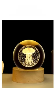 Macro detail of a 3D laser engraved jellyfish inside a glowing crystal ball on a wood base