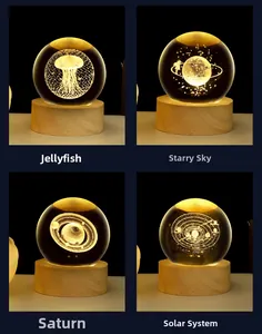 Detail of 3D crystal ball night lights with jellyfish, Saturn, and galaxy laser engraving