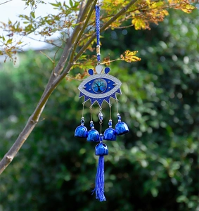 Detail of Turkish Evil Eye wind chime with Tree of Life emblem and blue tassels