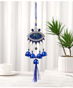 Detail of blue evil eye wind chime with tree of life emblem, bells and blue tassels
