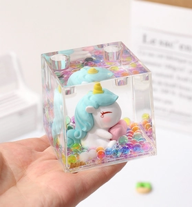 Detailed view of the cute unicorn acrylic oil drop pen holder with colorful floating beads.