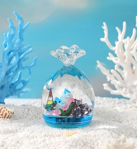 Macro detail of candy-shaped ocean liquid hourglass with dolphins and coral reef