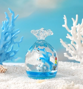 Detail of a liquid motion ocean bubble timer with dolphins in a clear lucky bag shape