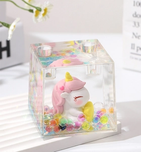 Close up view of the cute unicorn acrylic liquid pen holder with colorful glitter beads inside.
