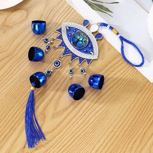 Blue evil eye hanging ornament with tree of life design and metal bells for home decor