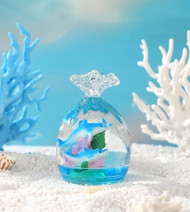 Macro shot of liquid motion bubble timer with ocean dolphins and coral in sandy beach scenery