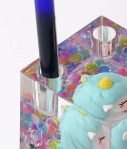 Detailed view of the cute unicorn liquid acrylic pen holder, transparent design with cute toy.