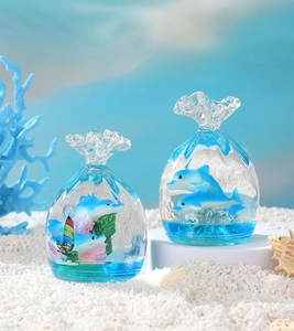 Detail of two creative ocean-themed liquid hourglass pouches with dolphins and corals