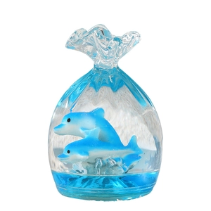 Liquid hourglass toy with blue dolphins inside a transparent bag-shaped motion timer