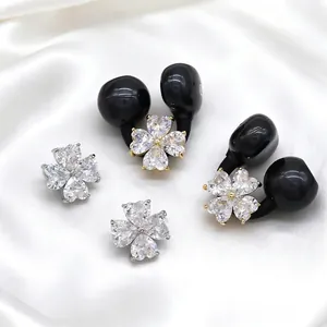 Elegant black Bluetooth earphones featuring sparkling zircon flower charms on white silk